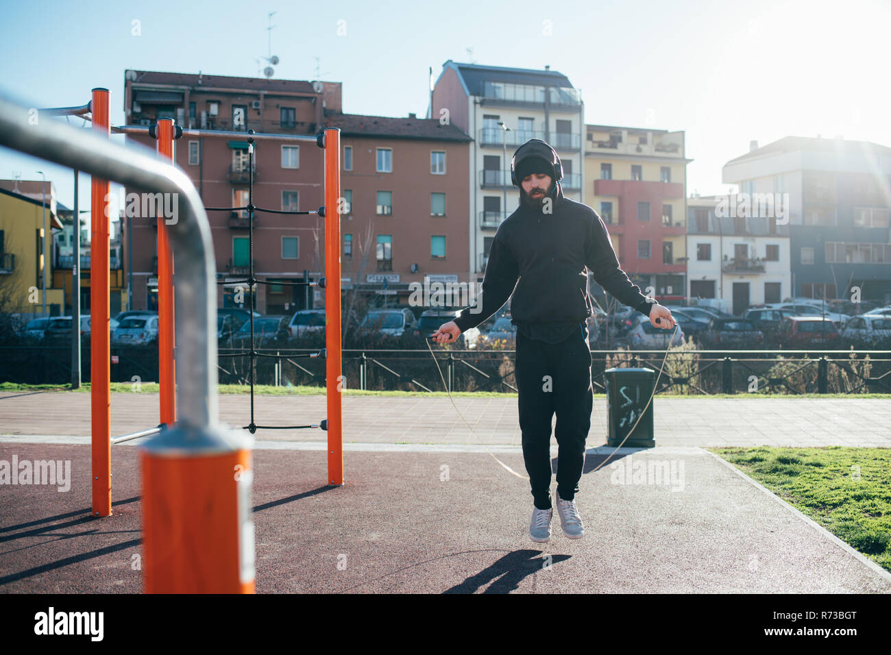 Man skipping in outdoor gym Stock Photo