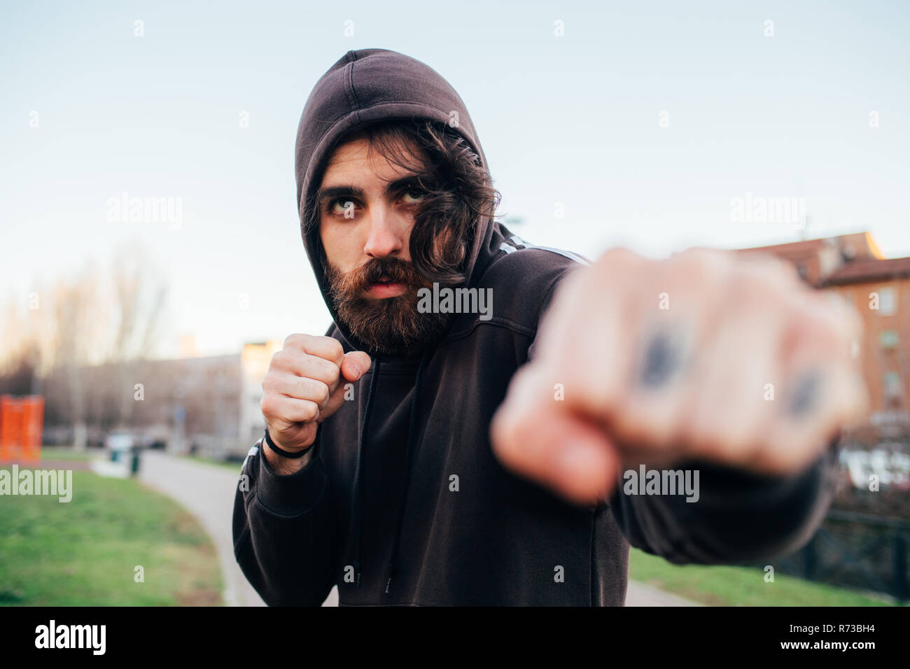 Man in hoodie in fighting pose Stock Photo
