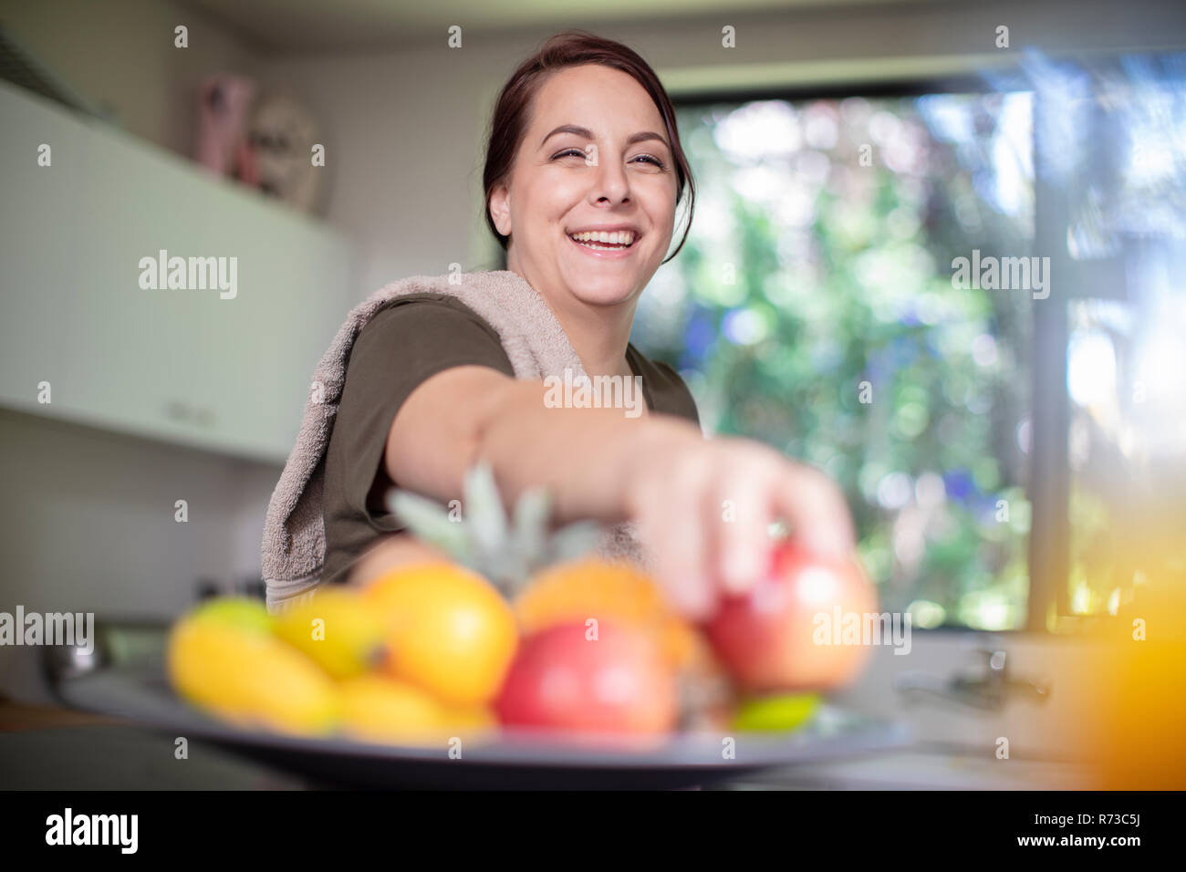 Woman having fruits for breakfast at home Stock Photo