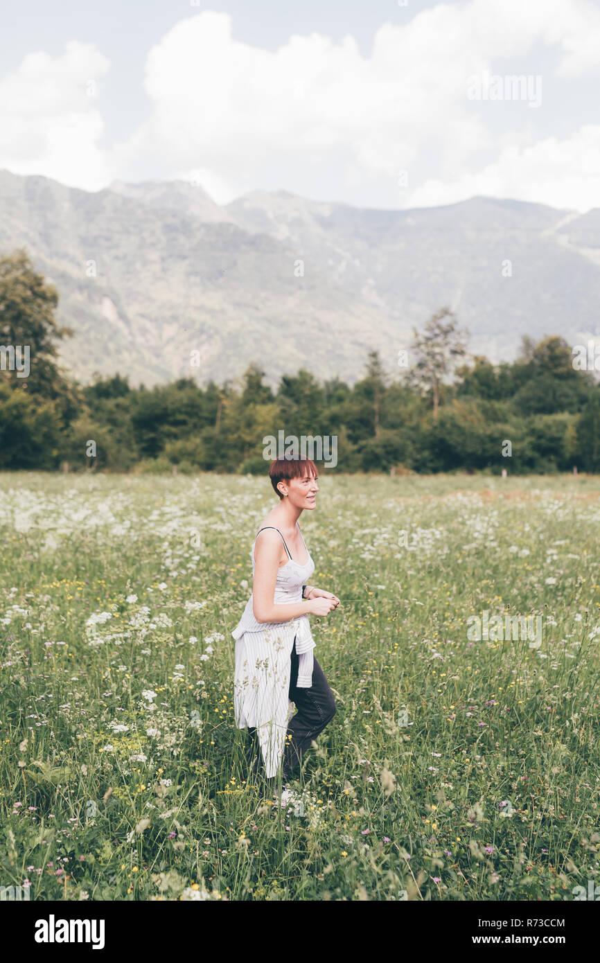 Young woman in wildflower meadow, Primaluna, Trentino-Alto Adige, Italy Stock Photo