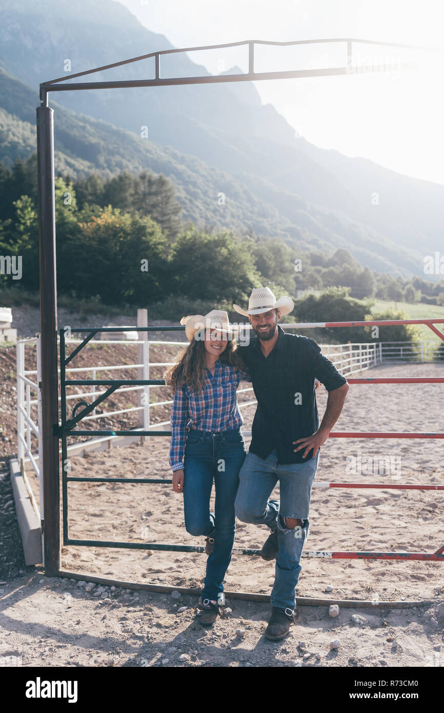 Cowgirl and boyfriend in rural equestrian arena, portrait, Primaluna, Trentino-Alto Adige, Italy Stock Photo