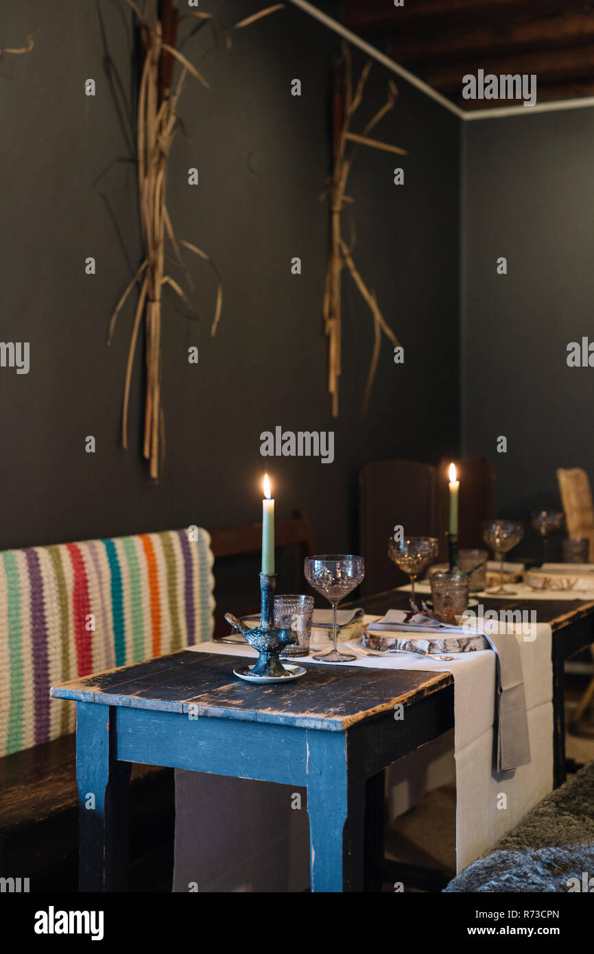 Prepared tables with lit candles in rustic restaurant Stock Photo Alamy