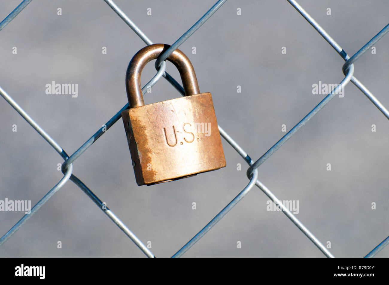 A copper lock on a wire fence Stock Photo Alamy