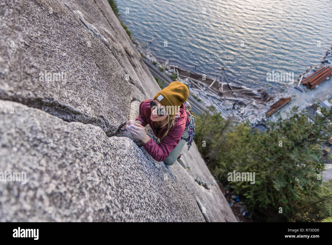 Rock climber gripping onto cracks, Malamute, Squamish, Canada Stock Photo