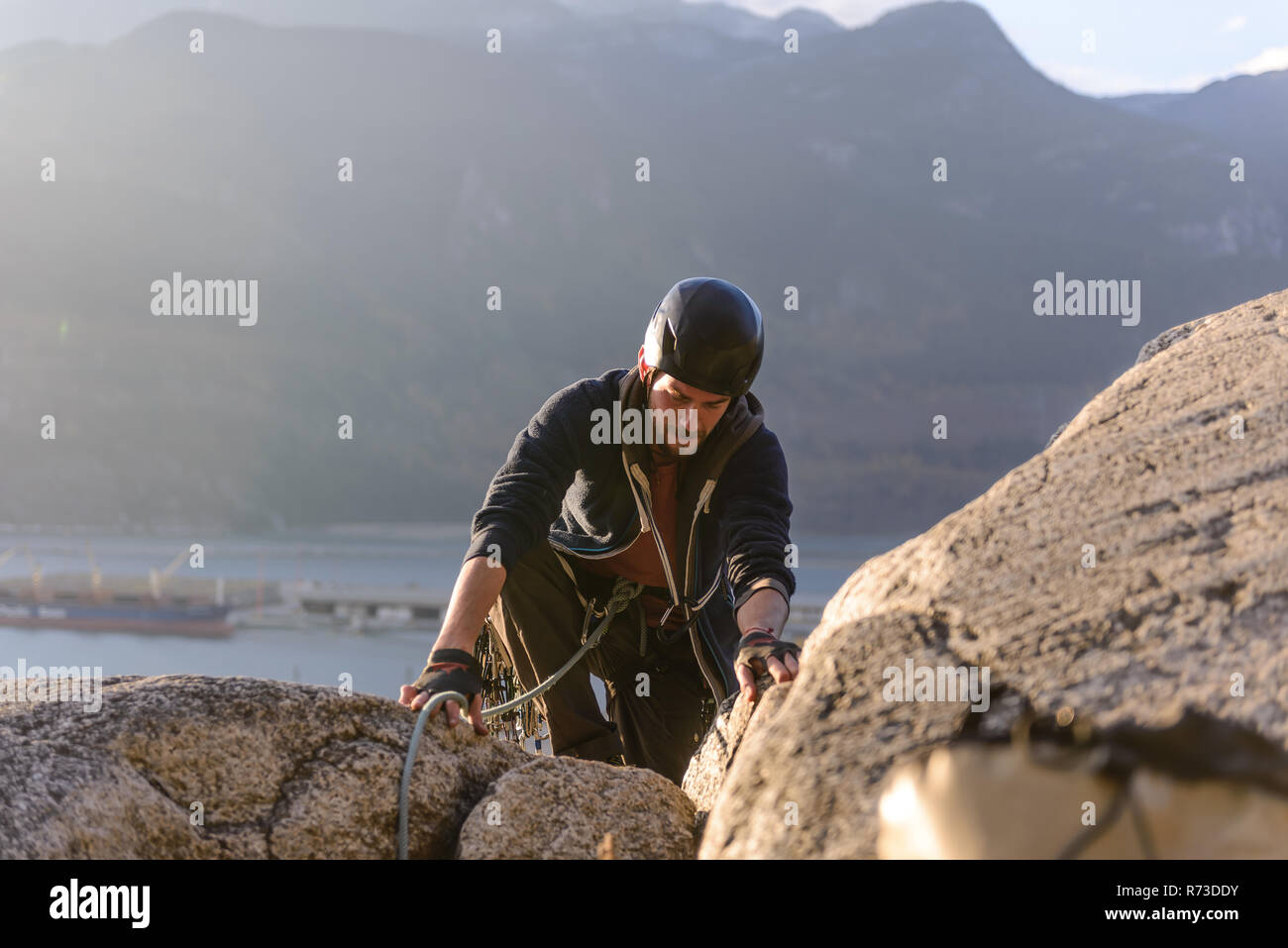 Rock climber using safety harness ropes, Malamute, Squamish, Canada Stock Photo