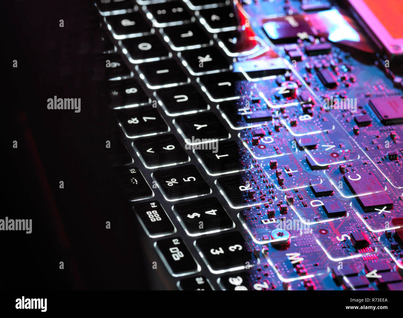 Multiple exposure of laptop computer showing keyboard and circuit board below Stock Photo