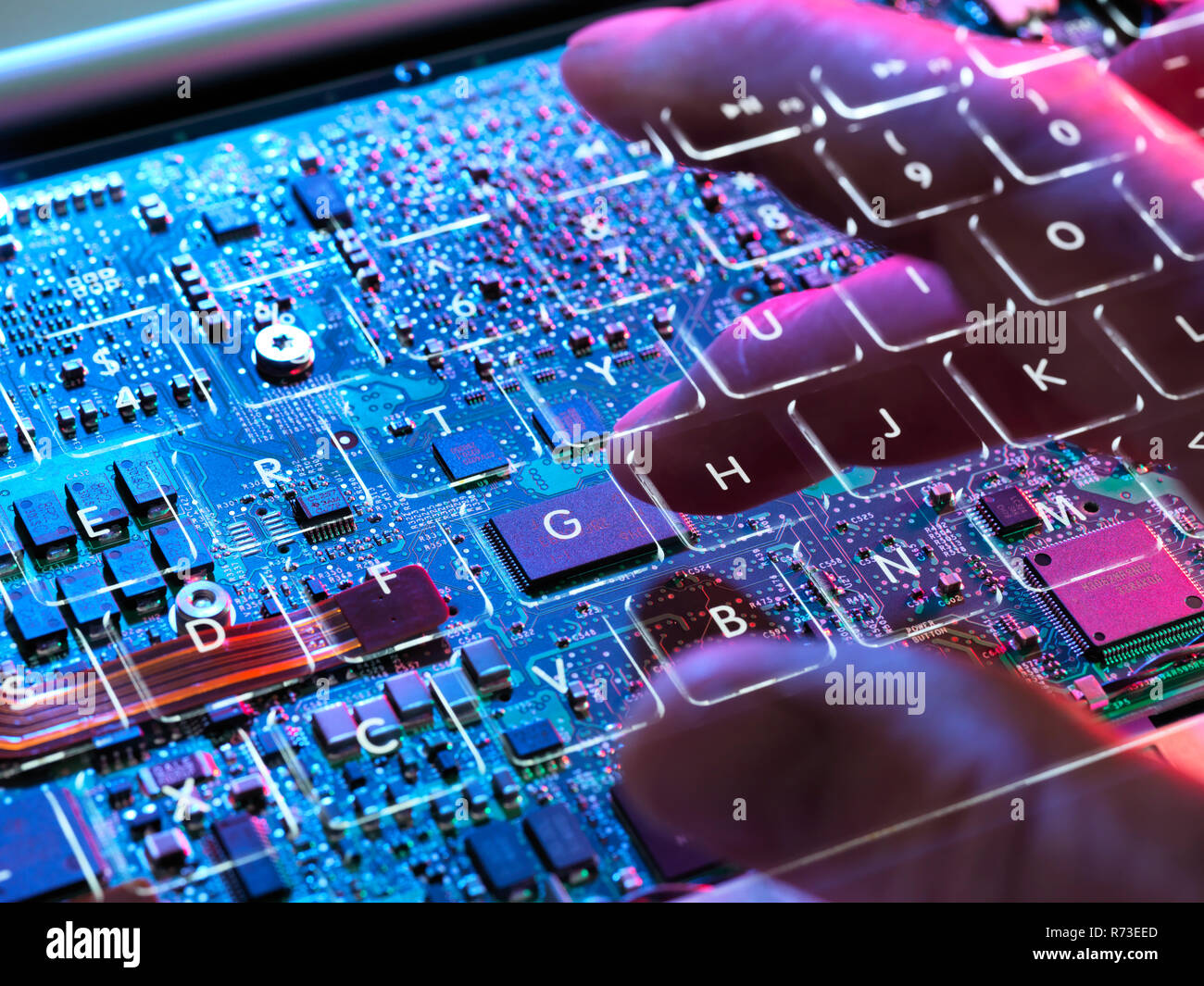 Multiple exposure of a laptop computer showing  a invisible computer hacker working at a keyboard and circuit board below Stock Photo