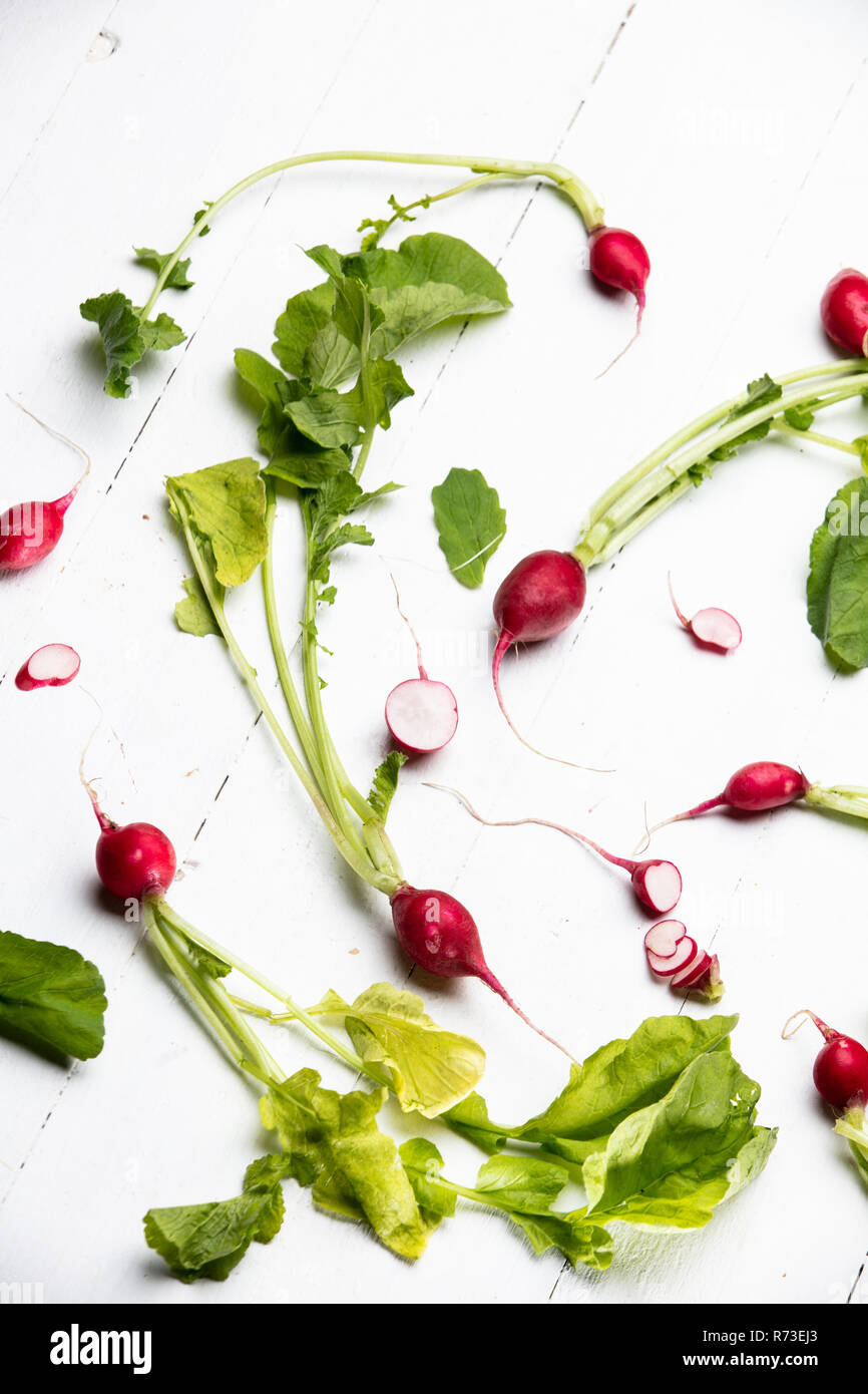 Radishes with stems and leaves, still life, overhead view Stock Photo