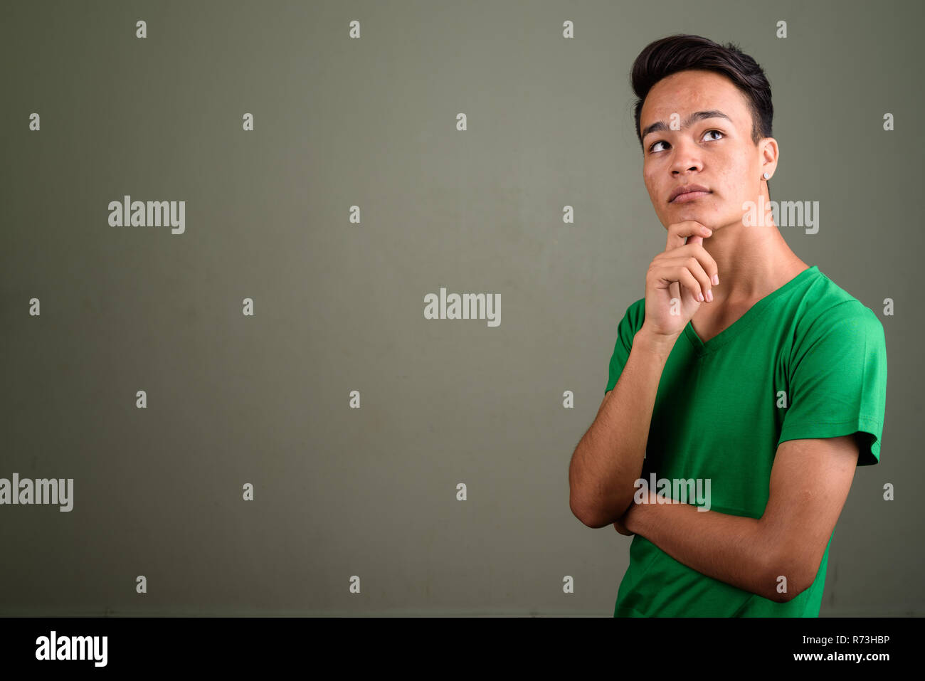 Young handsome Indian man against colored background  Stock Photo