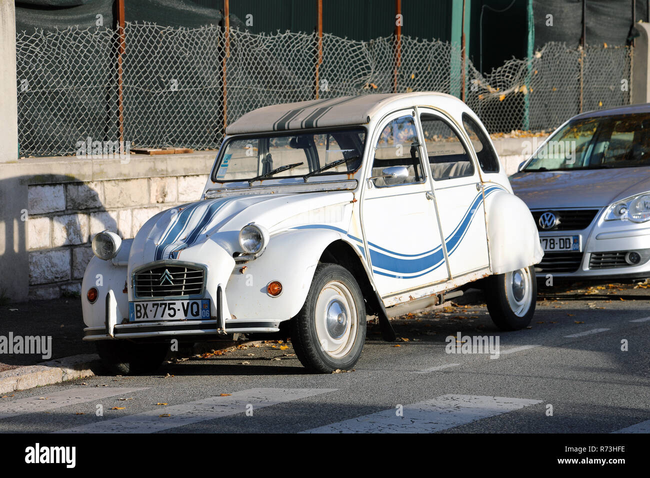 Roquebrune-Cap-Martin, France - December 4, 2018: White And Blue Striped Old Car Citroen 2 CV Parked On The Street, French Riviera, France, Europe, Cl Stock Photo