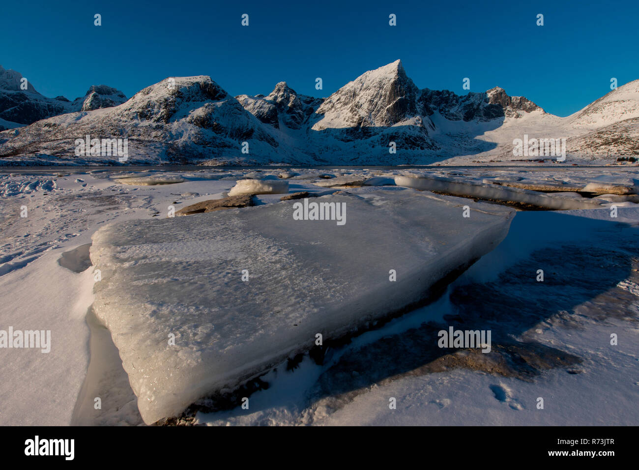 Breaking ice, Fjord near Flakstad, Flakstad, Lofoten Islands, Nordland, Norway Stock Photo