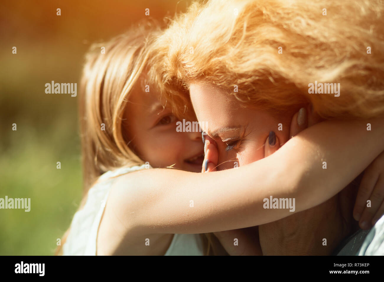 Close-up portrait of little daughter hugging her disabled mother Stock Photo