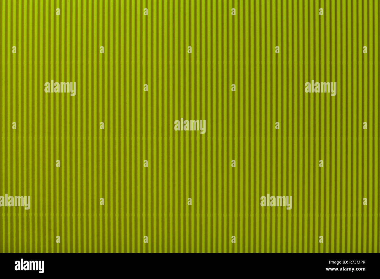 Texture of corrugated dark green paper, macro. Striped pattern of olive cardboard background, closeup. Stock Photo