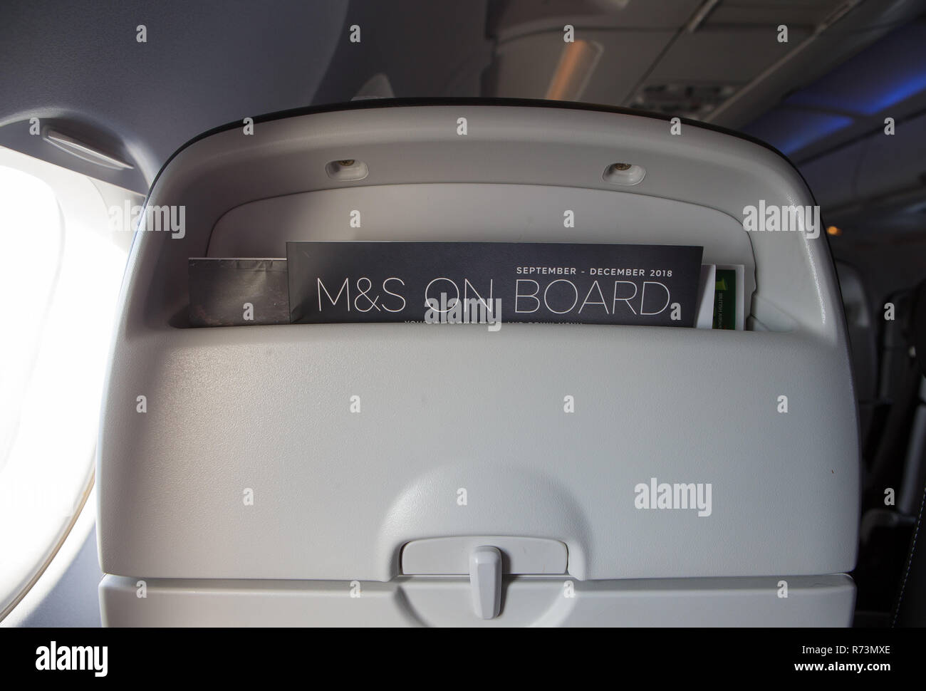 The Marks and Spencer M&S on board food menu and magazines including 'High Life' in the seat pocket of a British Airways Airbus A320 Stock Photo