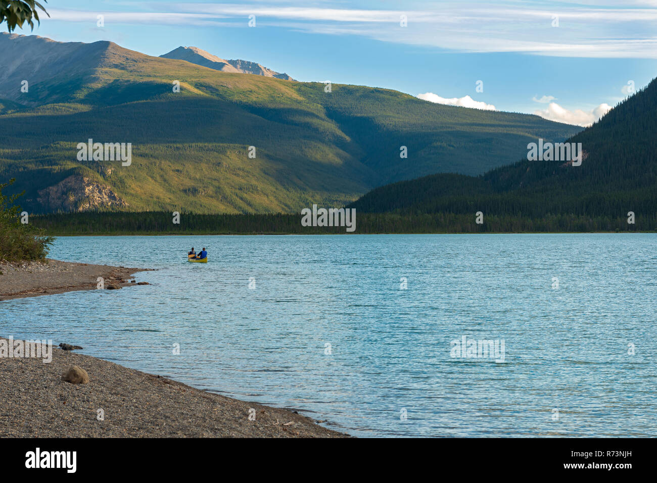 Rowing a canoe in the lake at Muncho Lake Provincial Park, British Columbia, Canada Stock Photo
