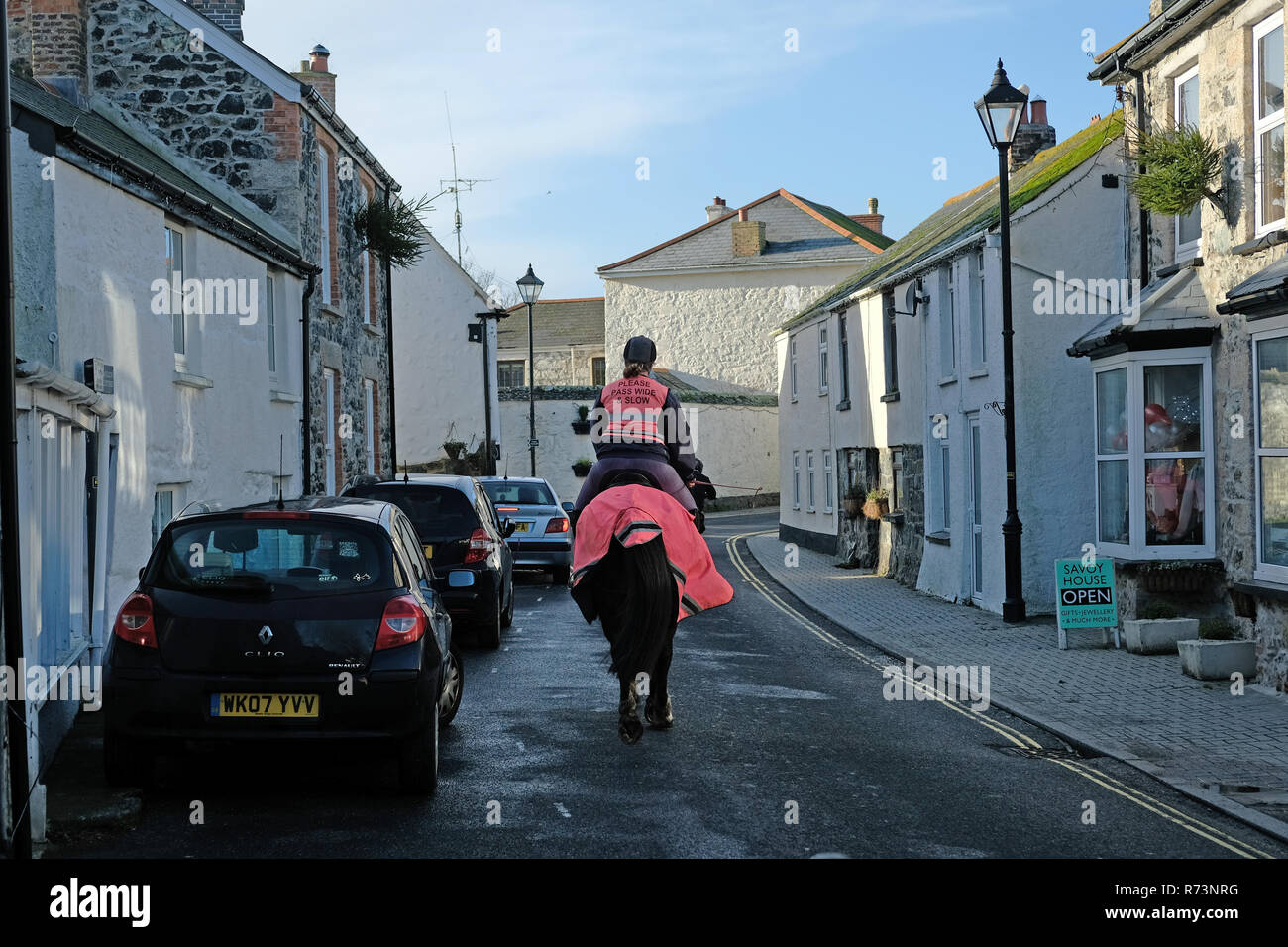 A horse and rider in a small village in Cornwall. Stock Photo