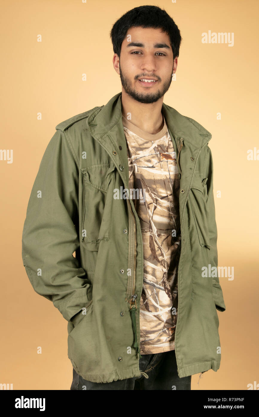 young man with green jacket Stock Photo