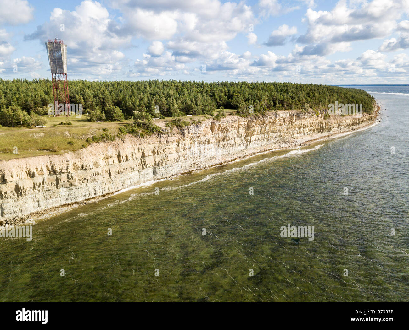 Panga coastal cliff and lighthouse (Panga pank, Mustjala cliff), northern shore of Saaremaa island, near Kuressaare, Estonia. North-Estonian limestone Stock Photo
