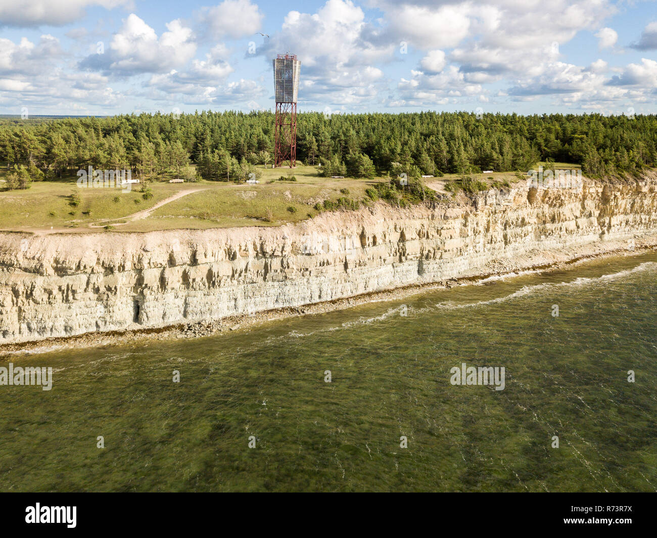 Panga coastal cliff and lighthouse (Panga pank, Mustjala cliff), northern shore of Saaremaa island, near Kuressaare, Estonia. North-Estonian limestone Stock Photo