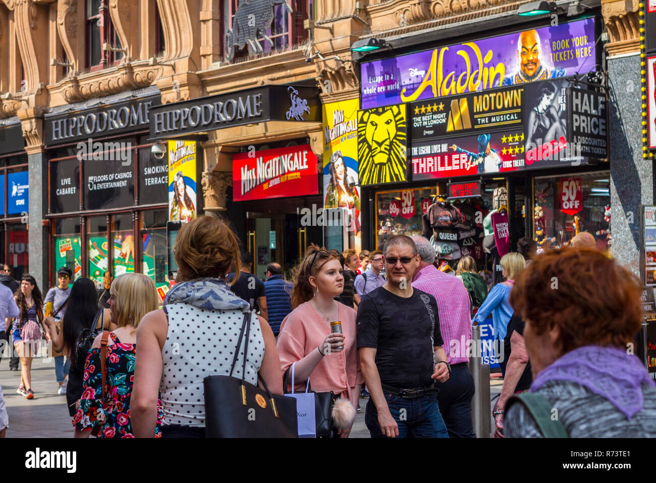 Visiting London concept, crowds tourists exploring visiting hot day, hippodrome leicester square, westend shows ticket outlets, central london, busy Stock Photo