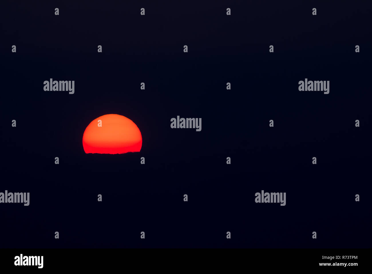 Setting sun and cloud isolated on black for text or copy. Stock Photo