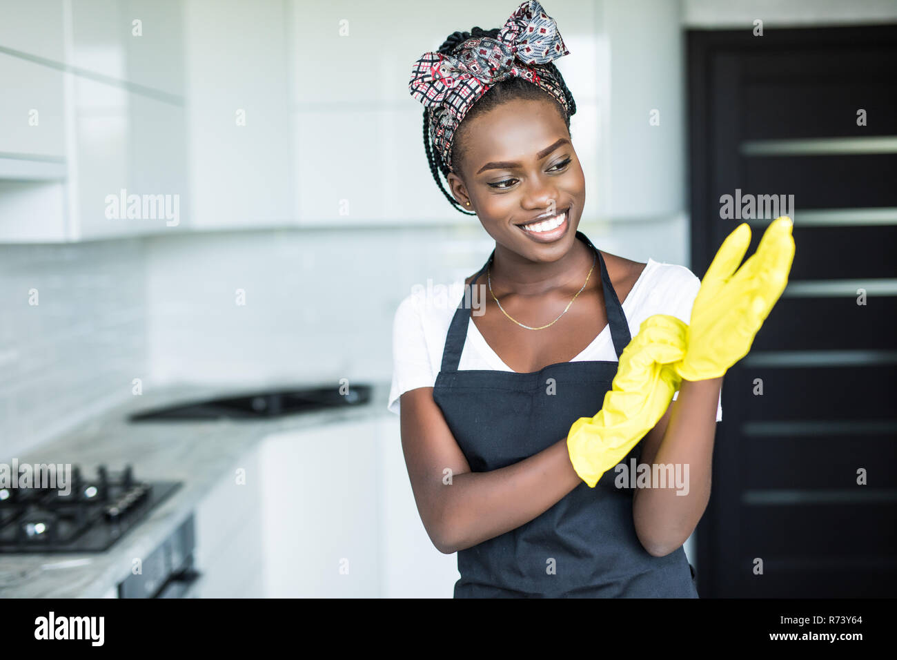 beautiful african woman cleaning cupboard Stock Photo