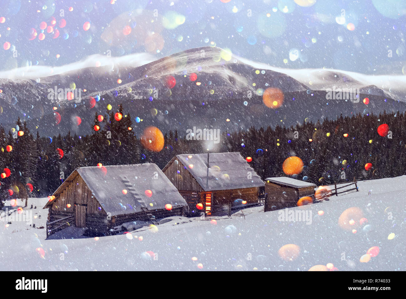 Fantastic night landscape glowing by moon light. Dramatic wintry scene with snowy house. Christmas holiday postcard collage. DOF bokeh light postprocessing effect Stock Photo