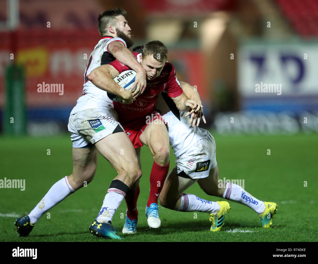 Scarlets' Tom Prydie is tackled by Ulster's Stuart McCloskey during Heineken Champions Cup, pool four match at Parc y Scarlets, Llanelli. Stock Photo