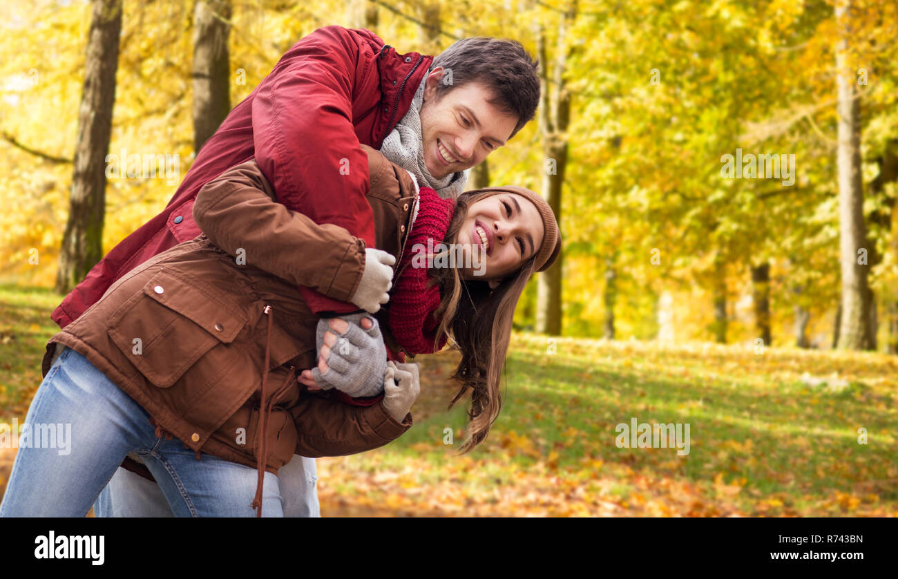 happy young couple having fun in autumn park Stock Photo - Alamy