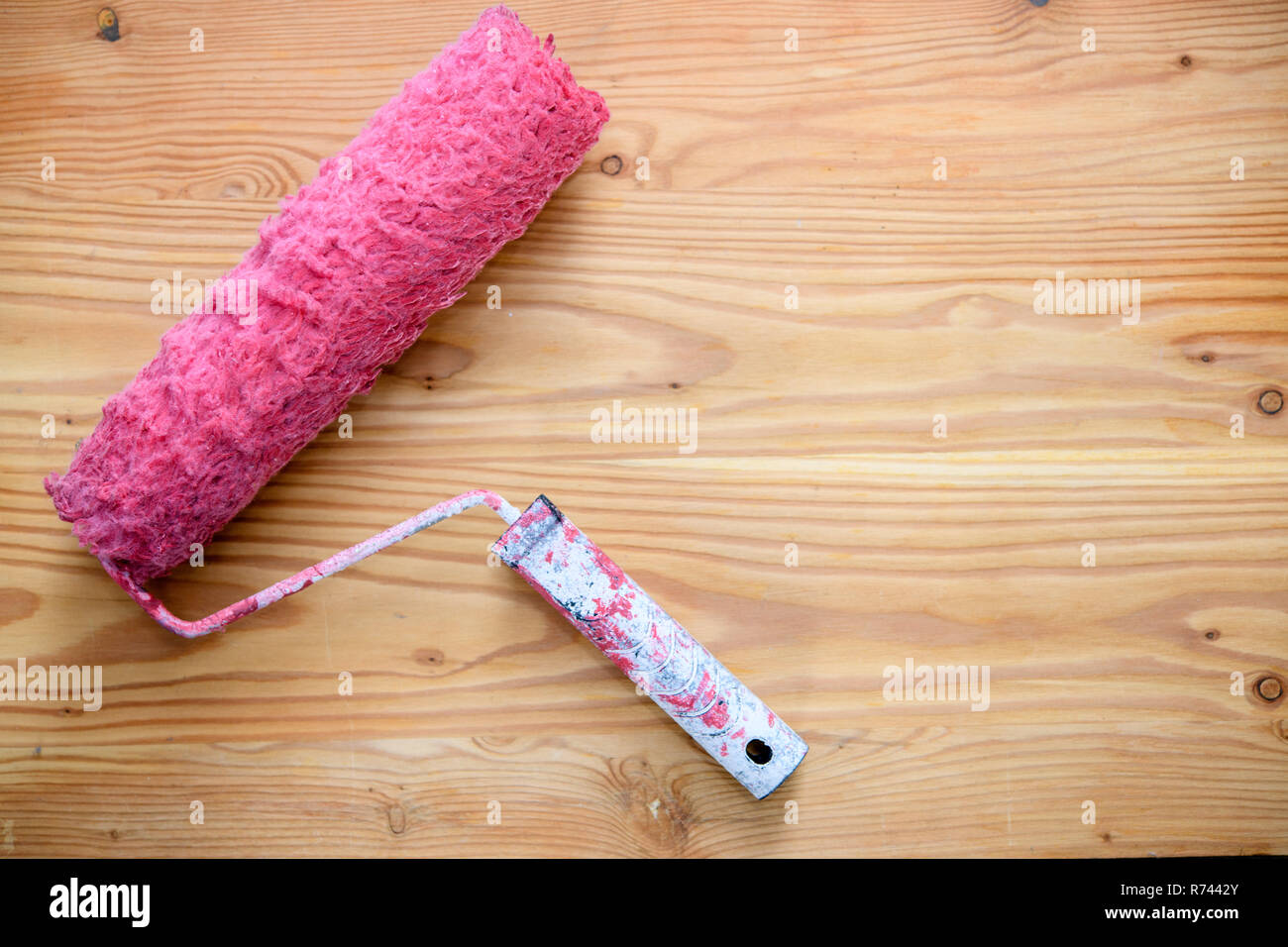 red used paint roller wooden ground Stock Photo - Alamy