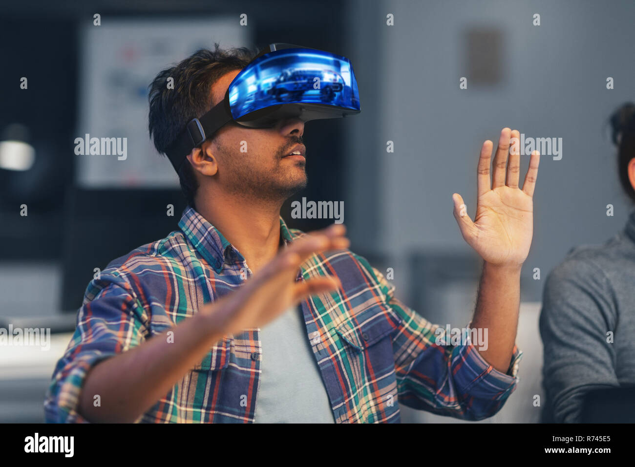 man in virtual reality headset at night office Stock Photo