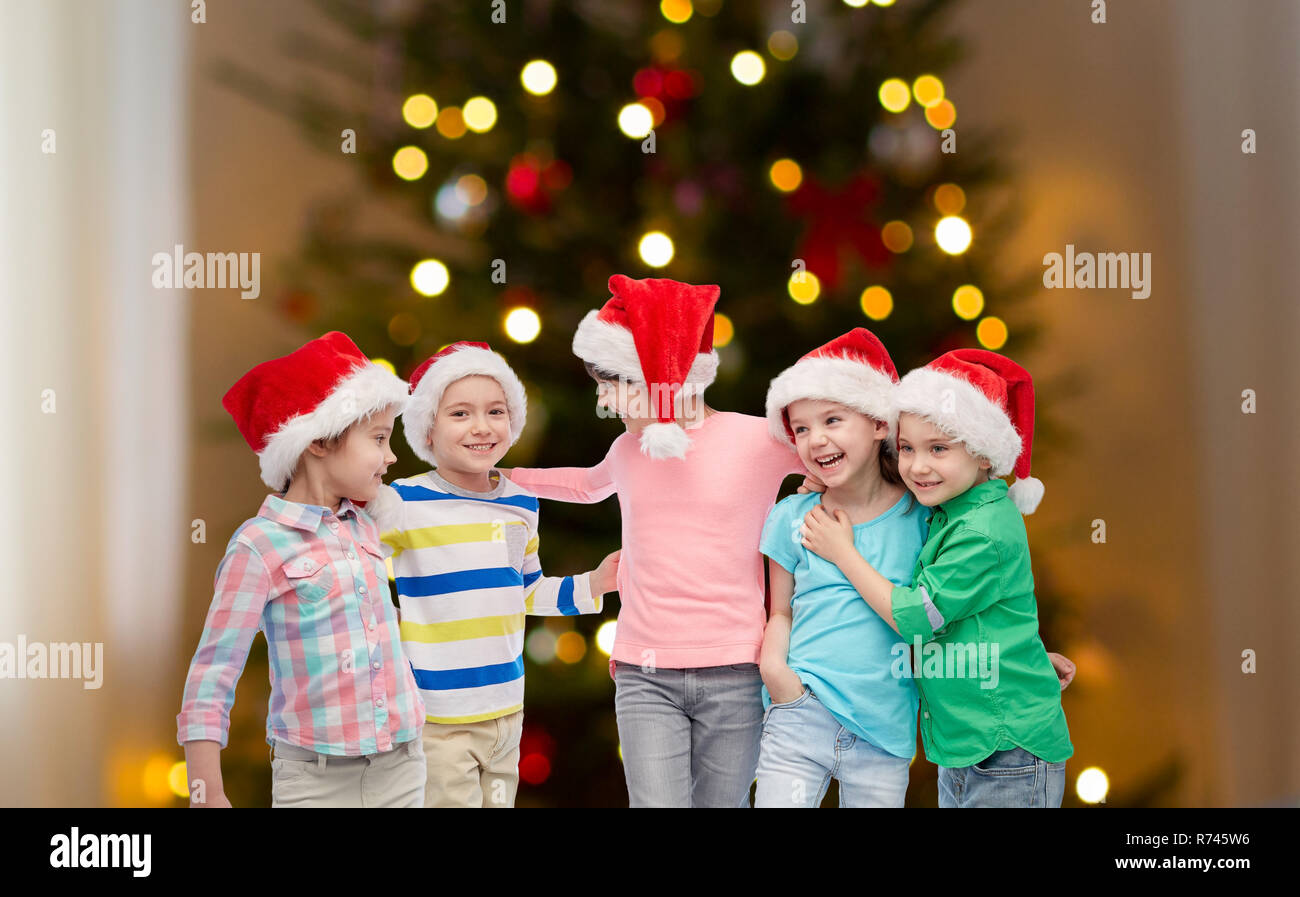 happy children over christmas tree lights Stock Photo Alamy