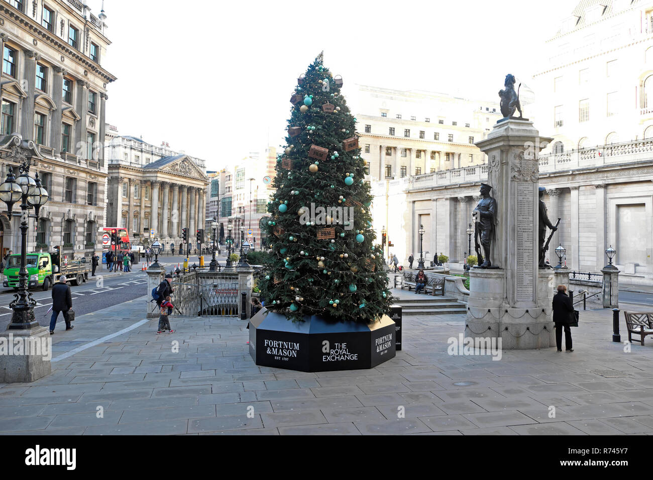 Fortnum & Mason Christmas tree outside the Royal Exchange and Bank of England with a street view of Mansion House City of London UK  KATHY DEWITT Stock Photo