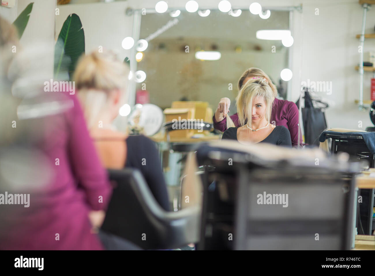Woman styling hair rear view hi-res stock photography and images - Alamy