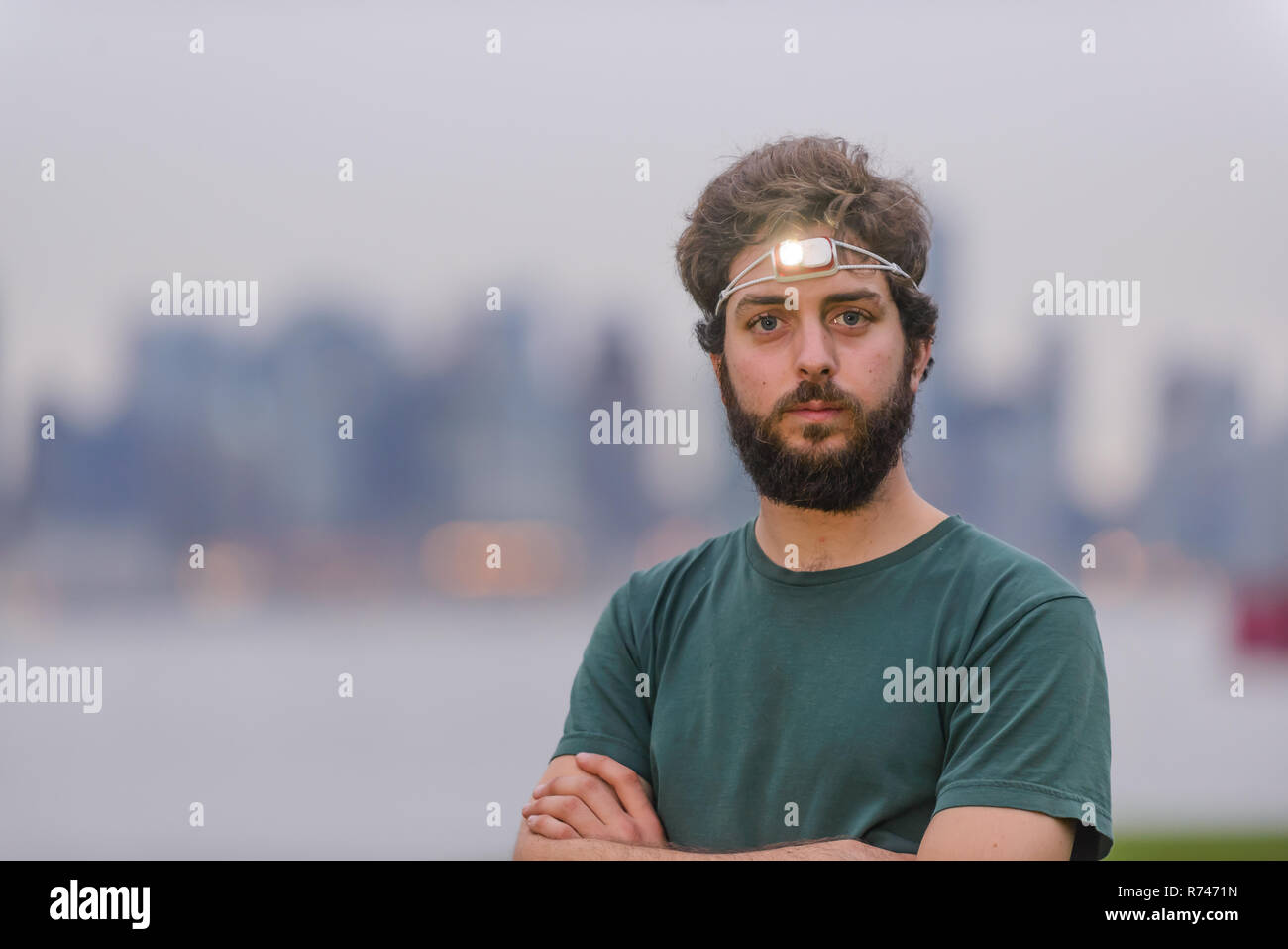 Runner with headlamp in urban area Stock Photo