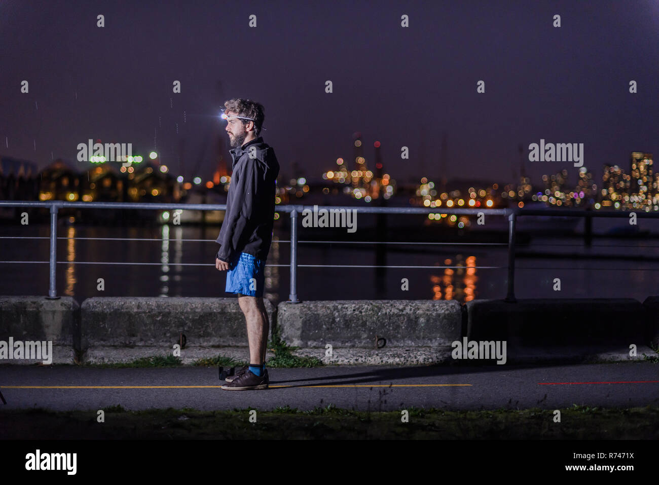 Runner with headlamp in urban North Vancouver, Canada Stock Photo