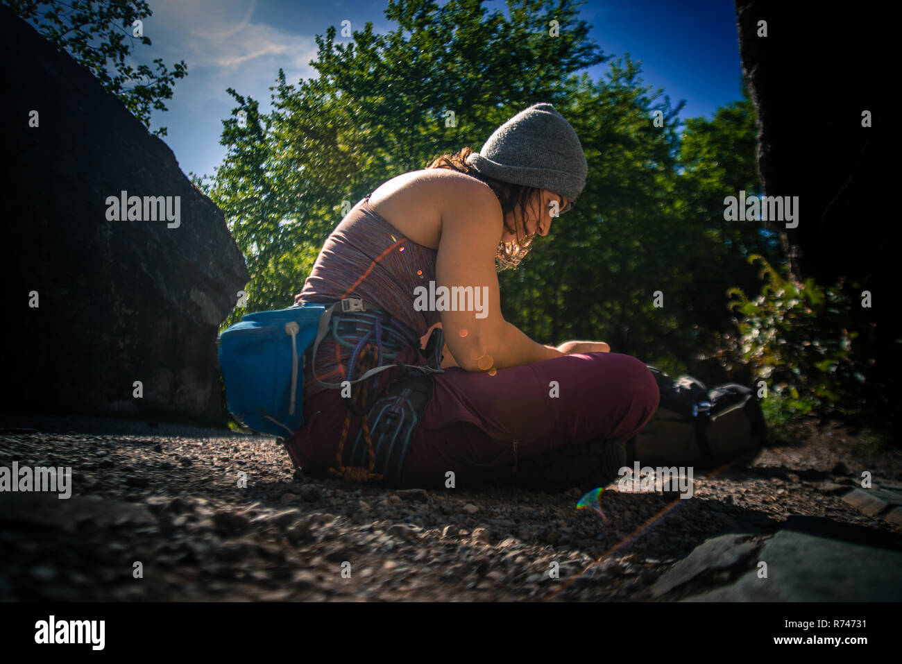 Young female rock climber preparing for climb, Smoke Bluffs, Squamish, British Columbia, Canada Stock Photo