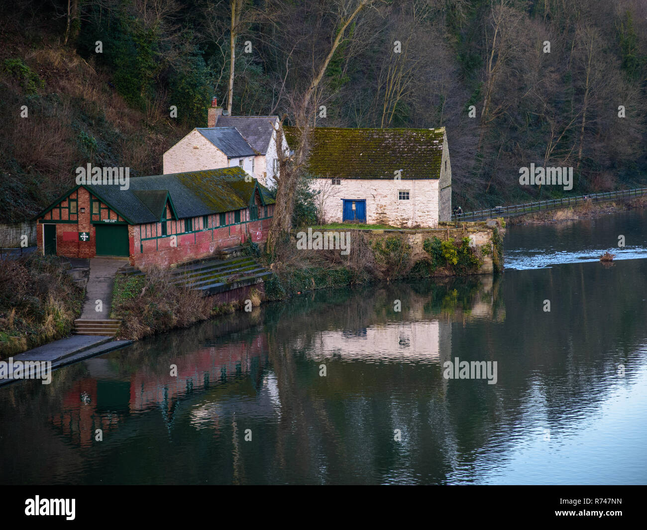 Durham, England, UK  January 29, 2017: The River Wear flows past the boathouse of Durham School's Boat Club in the steep wooded river valley through t Stock Photo