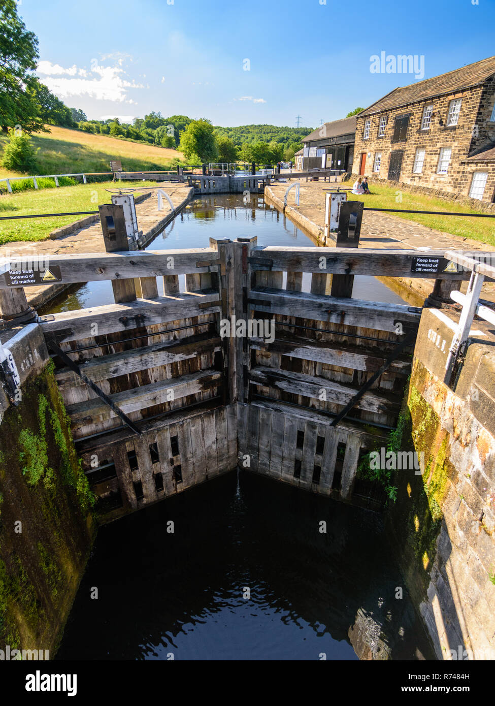 Leeds, England, UK - June 30, 2015: The staircase locks and Lock Keeper's Cottages at Dobson Locks on the Leeds and Liverpool Canal in the Leeds/Bradf Stock Photo