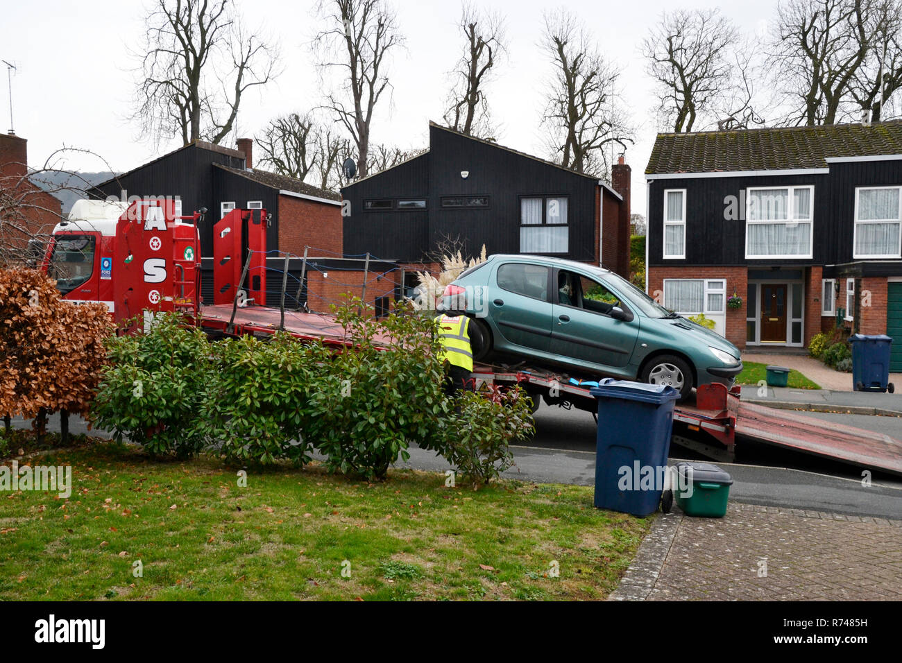 Car being loaded onto lorry, destined for the scrap yard, recycling, at the end of its life Stock Photo