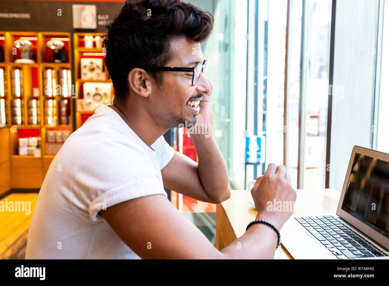 Man using laptop in cafe Stock Photo