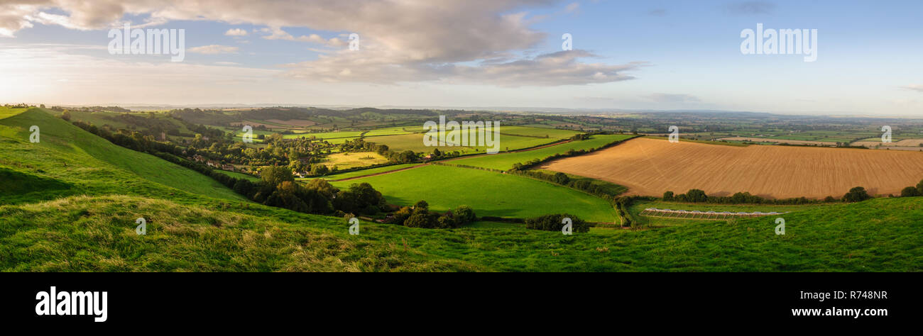 Morning light illuminates the landscape of the Somerset Levels viewed from Corton Beacon hill in South Somerset, England. Stock Photo