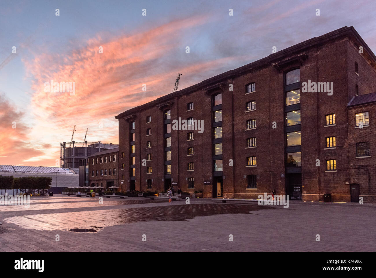 London, England, UK - June 15, 2017: Sun sets behind the brick LNER King's Cross good warehouse, now Central Saint Martin's College of the University  Stock Photo