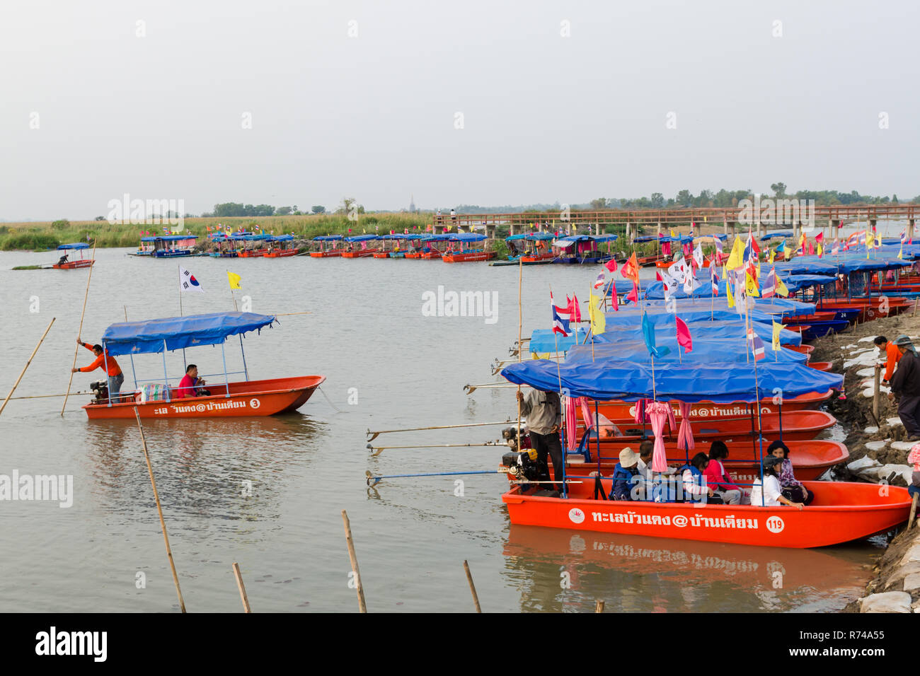 Tourists taking small boats to visit the Red Lotus Lake (Talay Bua Daeng), Kumphawapi, Udon Thani, Thailand Stock Photo