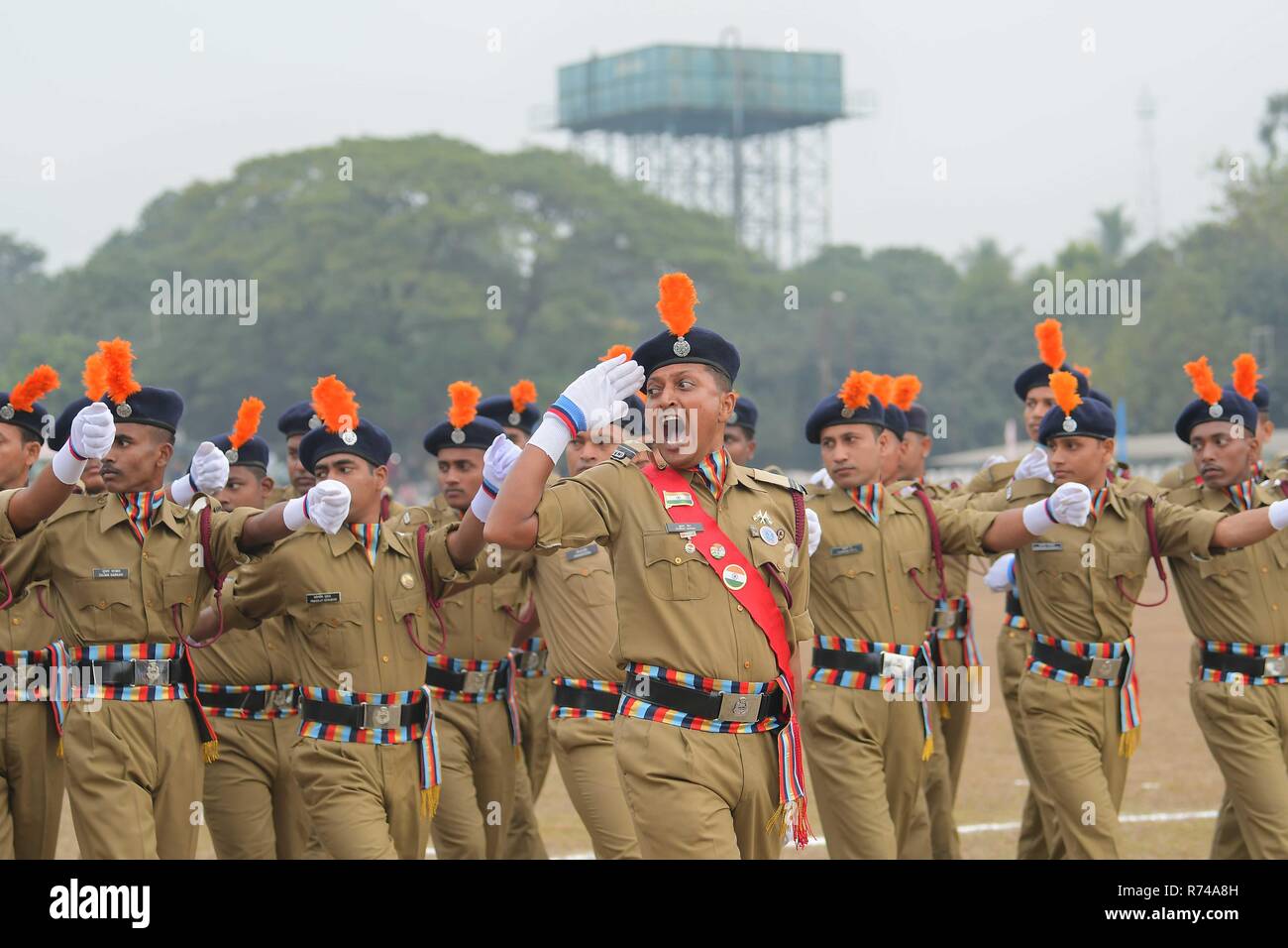 Home Guard and civil defense personnel seen parading on the occasion of 56th all India Home Guard and Civil Defense Raising day, at the police ground in Agartala, capital of the Northeastern state of Tripura, India. The Home Guard is an Indian paramilitary police force. It is a voluntary force, tasked as an auxiliary to the State police. The Home Guard was reorganized in 1962, after the war with China. Civil defense or civil protection is an effort to protect the citizens of a state from military attacks and natural disasters. It uses the principles of emergency operations: prevention, mitigat Stock Photo