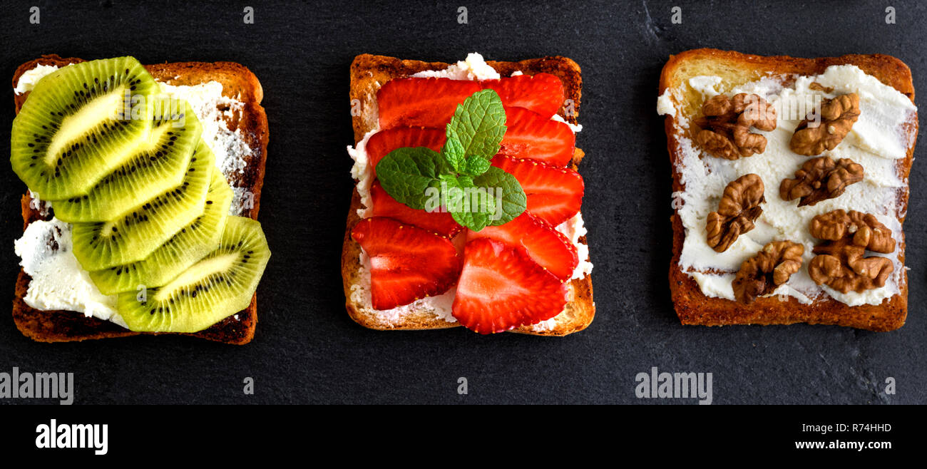 three toasts with mild cottage cheese, strawberries, kiwi and nuts ...