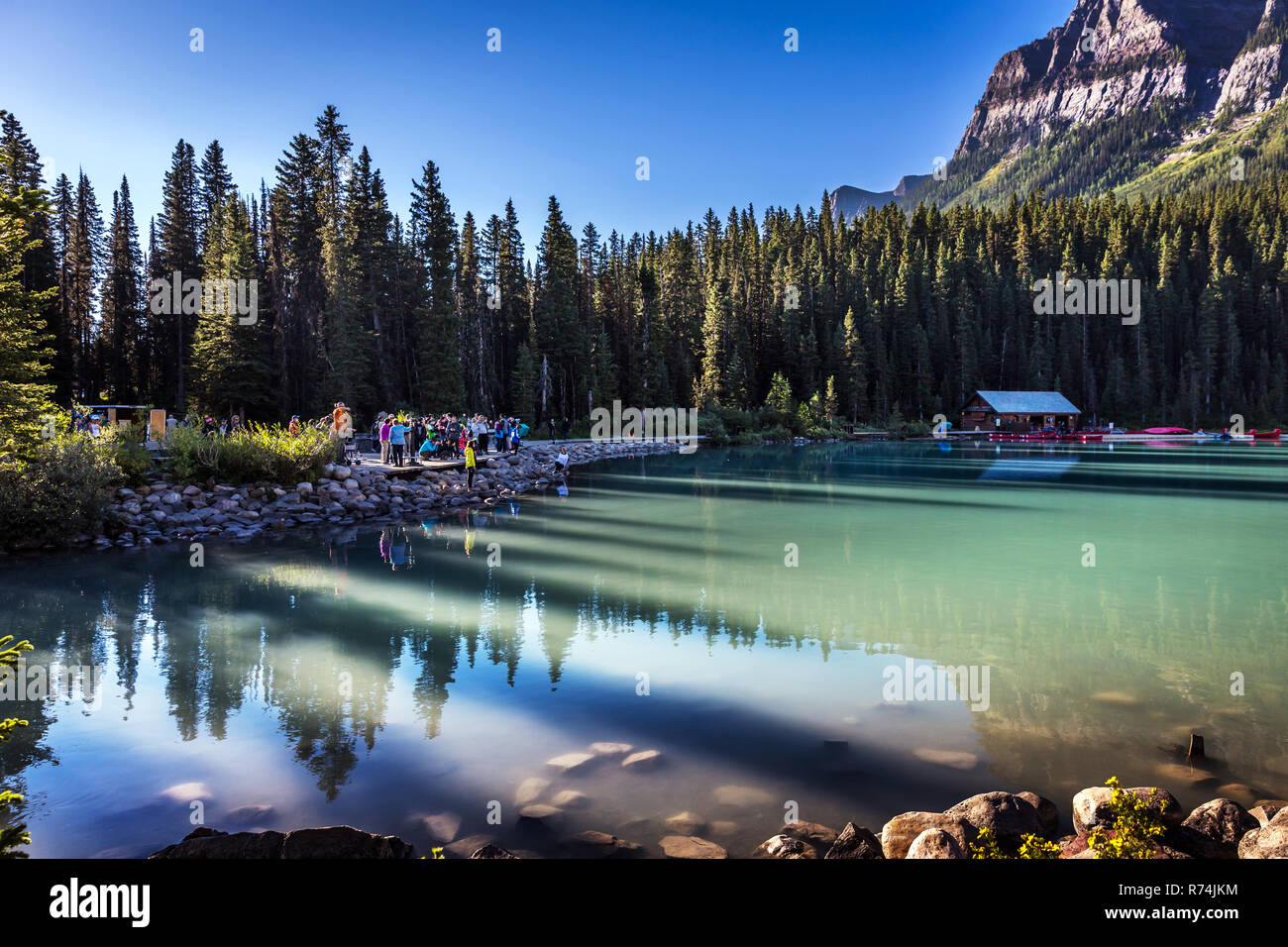 Banff, Canada - Sep 13th 2018 - Group of tourists taking pictures at sunrise lights in Lake Louise Stock Photo