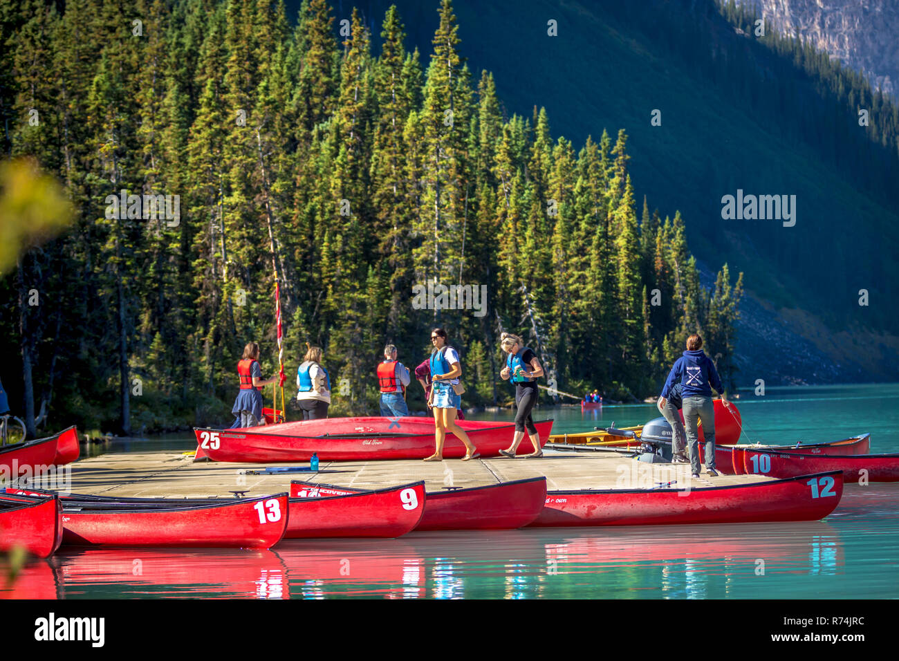Banff, Canada - Sep 13th 2018 - Group of tourists renting kayaks with pine trees around it at Lake Louise in Canada Stock Photo