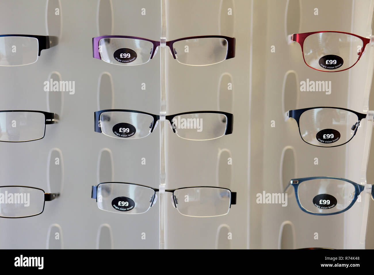 Opticians display wall of glasses for sale Stock Photo - Alamy
