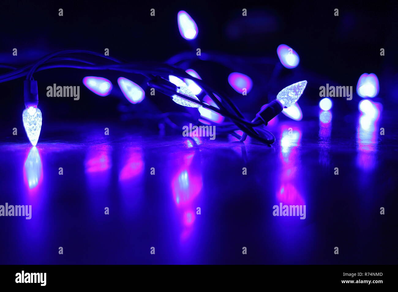Purple holiday lights reflected onto floor Stock Photo